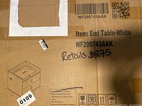 Photo of cardboard box front with item label, barcode, and simple line drawing of table.