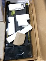View of unassembled treadmill base in box with foam packaging and protective cardboard pieces.