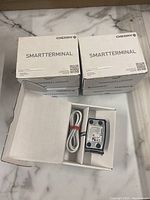 Five boxes labeled Cherry SmartTerminal, model ST-1144. One box open showing power adapter with white cable and black transformer.