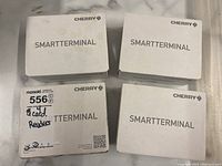 Four white boxes labeled 'SMARTTERMINAL' from Cherry, containing the card readers.