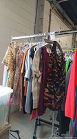 Racks of assorted women's tops, blouses and shirts in various colors and patterns hanging on hangers