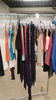 Photo of various tank tops, pants, and other hanging garments on rack