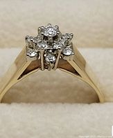 Front view of yellow gold band and diamond cluster