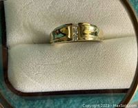 Front view showing split top design with three channel-set diamonds between polished gold sections.