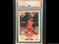 Front of 1990 Fleer Michael Jordan basketball card graded PSA 8 showing player mid-dunk, card details, and grading slab.