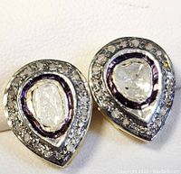 Close-up front view of silver Victorian style teardrop earrings highlighting the central diamonds and detailed setting.