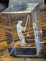 Side angle image showing the 3D laser etched golfer inside the clear glass cube paperweight.