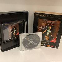 Front and back views of the Tomb Raider Premier Collection box with the game disc and manual.