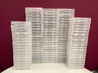 Stacked multiple clear plastic game cases shown from the front and side angles.