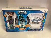 Full front view of the Skylanders Spyro's Adventure Wii Starter Pack box, displaying three character figures, the Portal of Power, and the game disc packaging