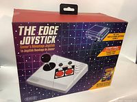 Box front shows the joystick image and key features such as 9-foot cable, turbo fire, compatibility with NES Classic Edition and Wii U, and bonus cheat code booklet.