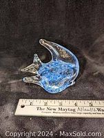Clear glass fish figurine viewed from side with ruler to show size approximately 11 cm tall