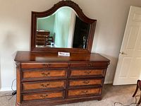 Full view of Aspenhome lowboy dresser with attached mirror. Shows dresser top and drawer fronts with ornate handles.