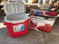 Open Coleman cooler showing interior, with EZ Clean surface cleaner in box beside it.