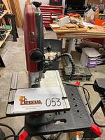 Front angled view of Skil benchtop band saw showing blade, work table surface with measurement guides, and flexible work light.