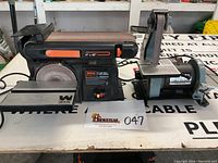Photo showing front and side view of Wen 4x36 belt and 6 disc sander and smaller Delta belt and 5 disc sander together on a workbench.
