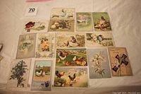 Array of 14 Easter postcards with vintage illustrations including flowers, chicks, children, and Easter greetings.