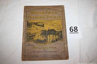 Front cover of the 1926 softcover book showing title, publication details, and historic images/maps on cover