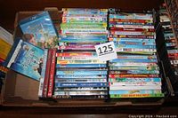 Photo of a large box filled with various children's DVD movies and two Blu-ray cases including Frozen II and Finding Dory.