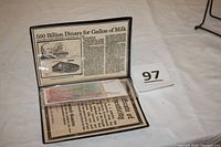 The opened display showing a newspaper clipping behind the banknote, pointing to its historical context of hyperinflation in Yugoslavia.