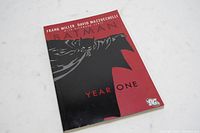 Front cover of the Batman: Year One hardcover graphic novel showing Batman in black and red stylized artwork.