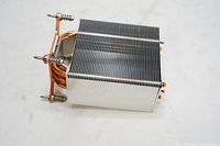 Front and side angle view of the CPU cooler showing aluminum fins and copper heat pipes.