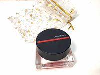 Image of the blush container with black lid featuring Shiseido branding, showing the compact size and design.