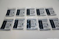 Ten sealed packages of Dura-Stick Premium 2 inch x 2 inch sticky square electrodes arranged in two rows of five packages each.