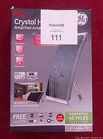Front of the boxed GE Pro Crystal HD Amplified Antenna showing branding, feature icons such as Full HD 1080p, 4K Ultra, and reception range of 40 miles.