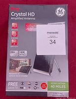 Front view of new GE Pro Crystal HD Amplified Antenna box showing product name, features such as Full 1080p and 4K Ultra HD support, horizontal or vertical stand included, and signal range up to 40 miles.