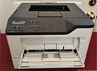 Front view of Lexmark B2339 printer with paper tray extended, showing control buttons and paper guides.