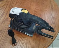 Mastercraft electric handheld sander showing handle, power cord, and rectangular sanding base.