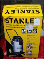 Photo of the yellow Stanley branded box with product information and image of the vacuum