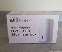 Front side of the box showing brand WillBrite and description 'Multi-Purpose UVC-LED Sterilizer Box' with image of the product.