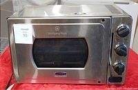 Full front view of the stainless steel Wolfgang Puck pressure oven showing front window and control panel.