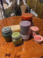 Wide view showing all candles arranged on wood table