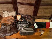 Photo of 7 assorted purses including some brown, snake print, and zebra print styles