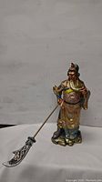 Full side view of the Guan Yu figurine showing the weapon and stance.