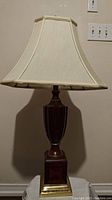 Front view of the lamp showing full height and beige fabric shade