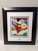 Full view of framed Indigenous print titled "Drummer" showing the artwork with black frame and matting.