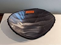 Top view showing the full 7 inch Nachtmann dark crystal bowl with wave pattern design and brand label.