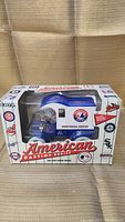 Front view of ERTL die cast metal bank in original box with clear display window showing blue and white Montreal Expos truck.