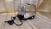 Sunbeam T-40-1 toaster showing right side and top slots with power cord secured