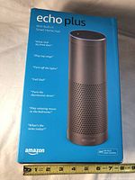 Blue box packaging for Echo Plus speaker showing product image and features