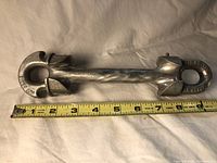 Full side view of the Sky Genie turnbuckle with measuring tape showing length about 9 inches.