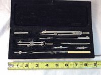 Full view of drafting set in original box with metal tools and measuring tape showing length