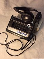 Sony Walkman WM-41 with headphones positioned on top showing front view with branding and cassette door