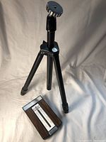 Photo showing the vintage telephone address book alongside the black camera tripod.