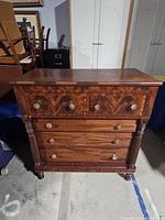 Full front view of dresser showing five drawers and carved column legs