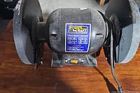 Photo of the bench grinder showing its overall condition and label.